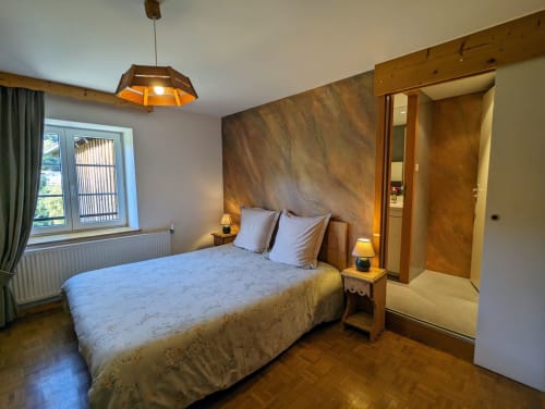Chambres d'hôtes le Grand Bienfaisy, chambre Bergeronnette : chambre avec lit queen-size, tête de lit en bois, vue sur le jardin