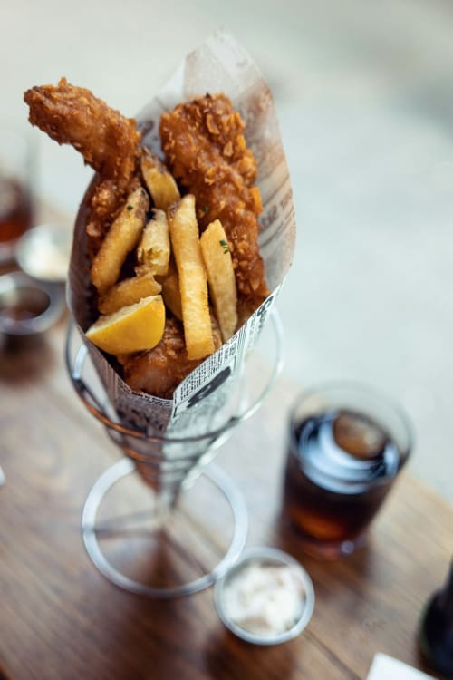 Crispy fish and chips with condiments at Brooklyn House, a London BnB in Southgate