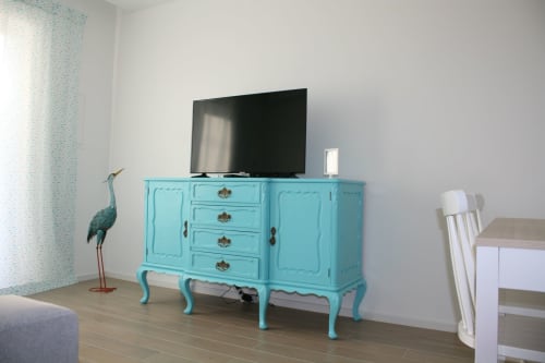 Turquoise vintage dresser with flat-screen TV in Egret Apartment at Recantus Comporta, Portugal