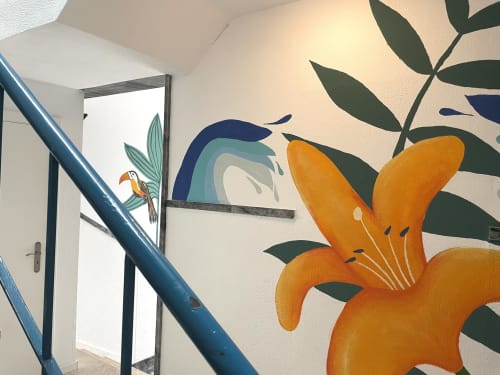 Colorful mural in Room B8 at Vila Alexandra hostel featuring orange lilies and a toucan, Costa da Caparica