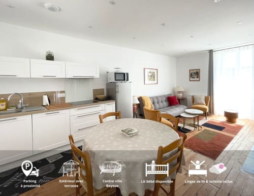 Le 58 Bayeux apartment: open-plan kitchen, dining table, living area with sofa and modern amenities