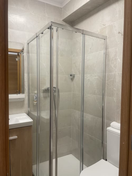 Modern shower enclosure in Room B2 at Vila Alexandra hostel, Costa da Caparica