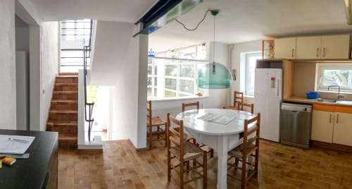 Cocina y comedor luminosos en Finques Garcia Enrich en Palafrugell con mesa de madera, escalera y electrodomésticos modernos