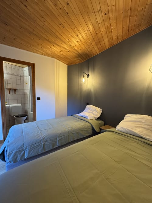 Comfortable twin room at Ardesia Morzine, ideal accommodation for a mountain stay
