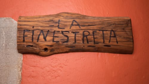 Letrero de madera que dice 'La Finestrella' en la casa rural Can Gat Vell de Girona, Empordà, Cataluña