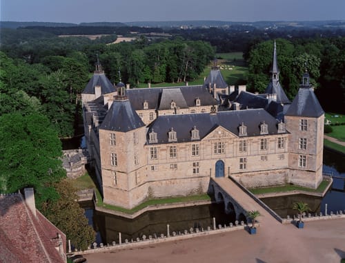 Château de Vaux Morvan, a historic French château with towers and moat, surrounded by verdant grounds near Étang sur Arroux