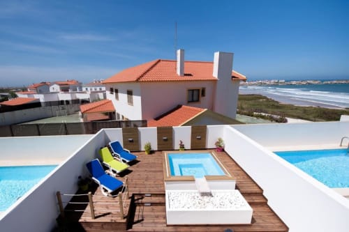 Home Alliance B&B in Bombarral, Portugal. Rooftop terrace with pools, loungers, and ocean views overlooking Óbidos coast.
