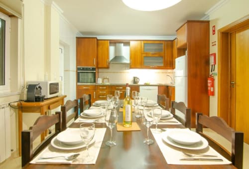 Dining area with wooden table and place settings at Home Alliance bed and breakfast in Bombarral, Óbidos, Portugal