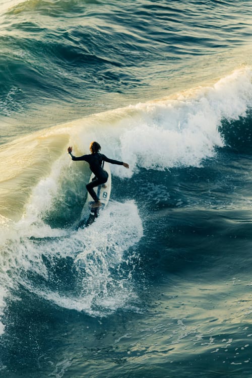 Surfer riding wave near Bombarral, Portugal - adventure activities near Home Alliance guesthouse