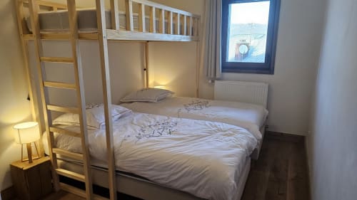Chambre douillette avec lit superposé en bois, draps blancs et vue sur les montagnes à L'écrin des sapins, Aime-la-Plagne