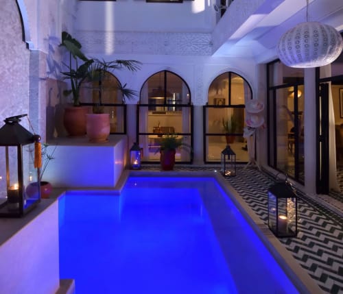Indoor pool at night at Riad Palau Marrakech, illuminated patio in the heart of the medina