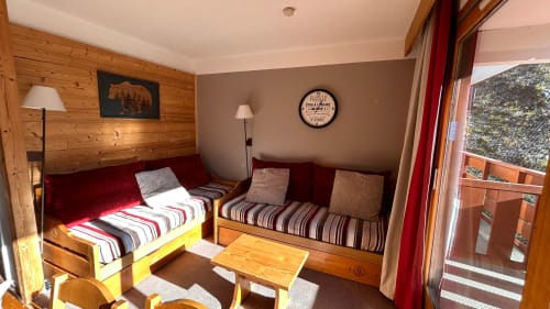 Petit appartement cosy à Méribel avec lits jumeaux, mobilier en bois et balcon aménagé vue sur les Alpes