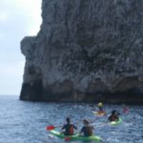 Kayakers paddling near dramatic cliff formations at Empordà-Catalunya coastal location near Can Gat Vell.