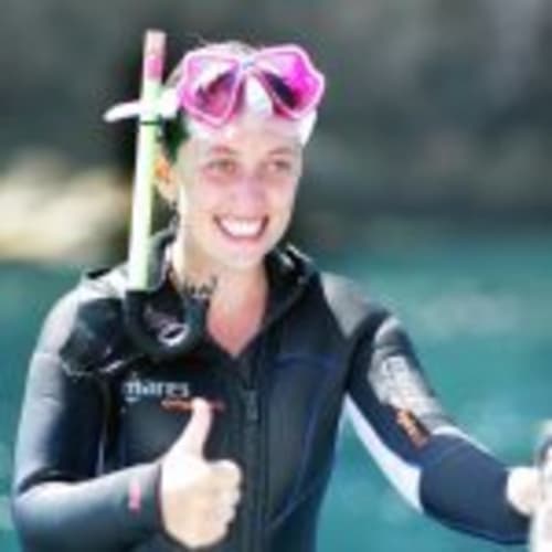 Young woman in snorkeling gear smiling at beach near Can Gat Vell B&B in Girona, Catalonia