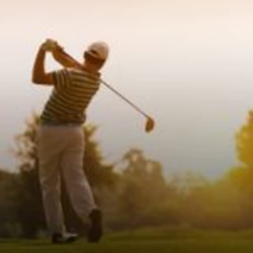 Golfer mid-swing at Can Gat Vell, a bed and breakfast in Girona, Empordà-Catalunya, Spain