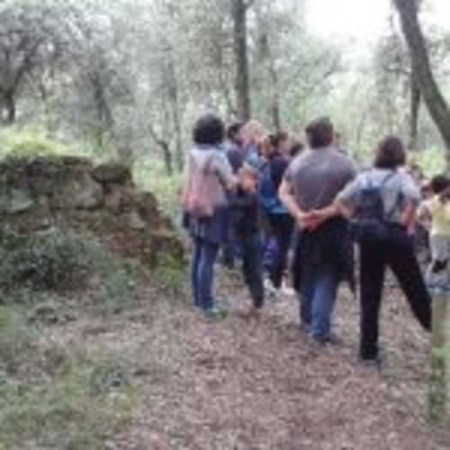 Group hiking on forest trail at Can Gat Vell in Girona, Catalonia, Spain