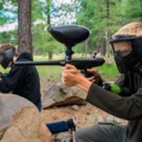 Paintball players with markers in Girona forest, outdoor activity at Can Gat Vell
