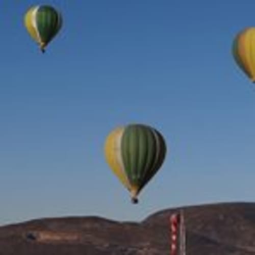 Hot air balloons floating over Girona landscape near Can Gat Vell bed and breakfast in Empordà, Catalunya