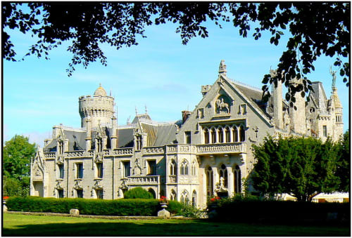 Ornate stone castle-style B&B with turrets and manicured gardens in Concarneau, France