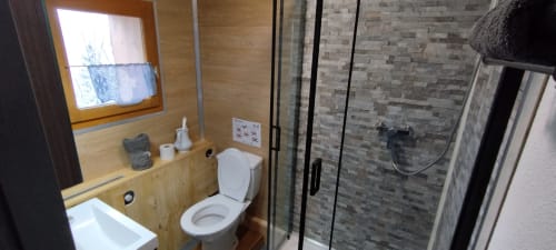 Modern bathroom in Girole room at L'étape Du Fanfoué, Chamrousse with shower, toilet, and wooden vanity