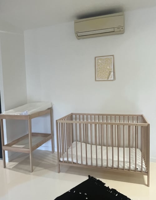 Kinderzimmer mit hölzernem Babybett, Wickeltisch und Klimaanlage in der Villa La Villa des Ecureuils in Boissieres