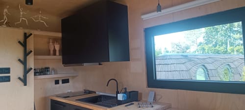 Modern kitchenette with flat screen TV in LEGO HOUSE cottage at Les Refuges Du Chalet, Jalhay, featuring garden view window
