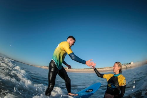 Surf instructors teaching at Costa da Caparica beach near Vila Alexandra hostel in Portugal