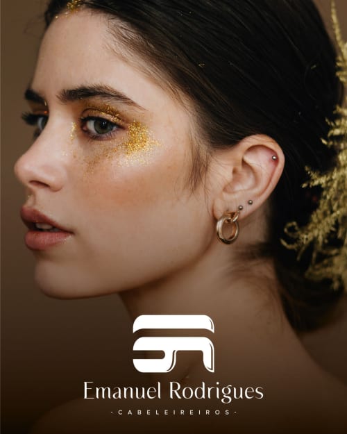 Mulher com maquiagem de glitter dourado nos olhos e brincos de argola, vista de perfil. Marca do salão Emanuel Rodrigues em Vila Alexandra