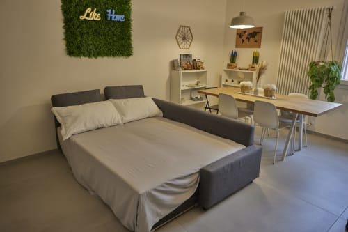 Modern studio apartment in Ferrara with sofa bed, dining area, and city view at LikeHome San Romano