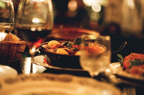 Elegant dinner setting at Quinta Do Fraguil with wine glasses, plated cuisine, and red berries garnish in Valença do Douro