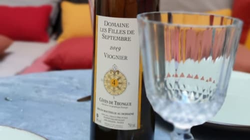 Viognier wine bottle from Domaine les Filles de Septembre with glasses in Pézenas apartment