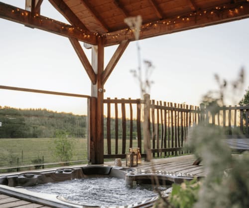Outdoor hot tub overlooking the countryside | Treehouse Getaway in France