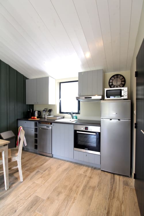 Cuisine moderne du gîte Vert au Moulin d'Angibaud avec électroménagers en acier inoxydable et vue sur le jardin