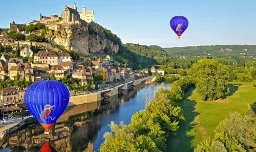 Hot air balloons over medieval Carsac-Aillac castle and river, Domaine De Campagnac B&B