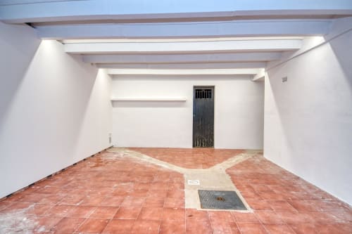 Empty garage with terracotta tile floor at Finques Garcia Enrich, Palafrugell