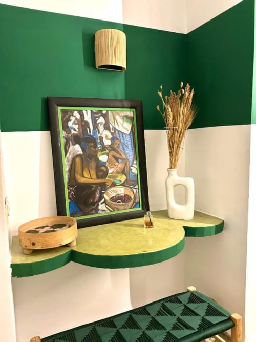 Jade room corner at Riad Les Lauriers Blancs, Marrakech, featuring green and cream walls, framed artwork, and decorative