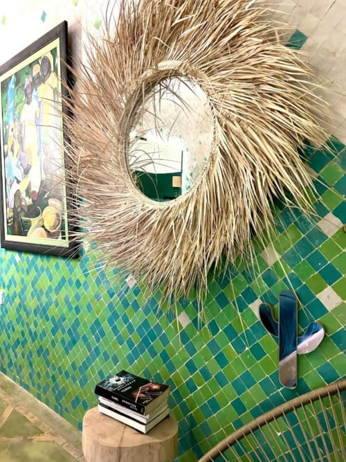 Jade room at Riad Les Lauriers Blancs, Marrakech, with green tile wall, decorative straw mirror, and framed artwork