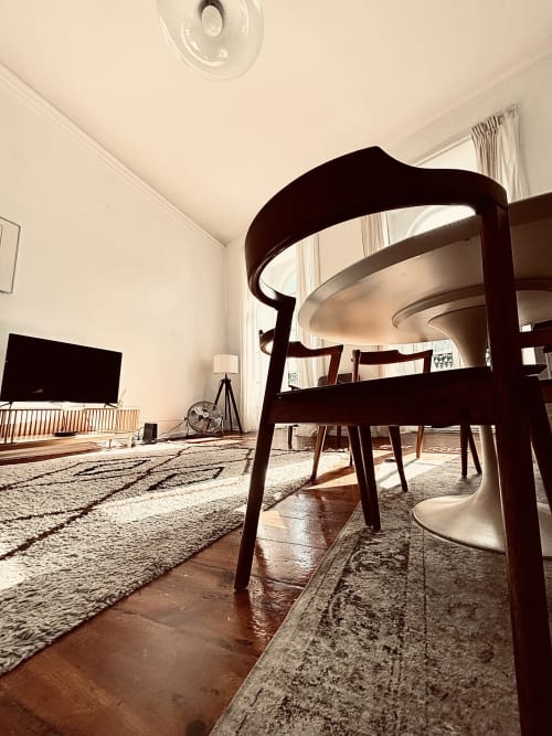 Modern living room in River 3Bedroom Apartment at Royal Prince Garden Apartments, Lisbon, with dark wood chairs, white