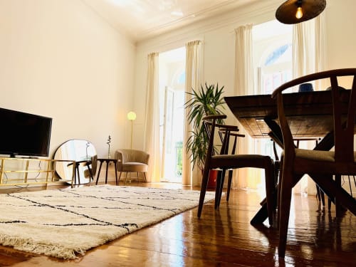 Spacious living room in Royal Prince Garden Apartments, Lisboa, with dining table, wooden furniture, and garden view through