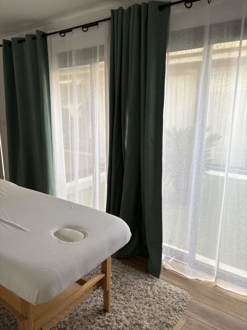 Spa-Massagebett mit weißem Bezug in hellem Zimmer mit grünen Vorhängen und Fenstern im Lady Jule B&B, Sainte-Luce-sur-Loire