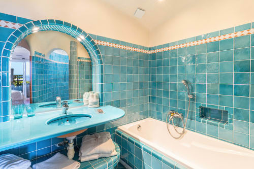 Salle de bains turquoise avec double vasque, baignoire et douche à la Villa Marina Di Cavu, Bonifacio