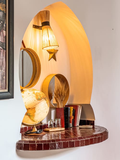 Decorative lamp display with globe and books in Ruby room at Riad Les Lauriers Blancs, Marrakech