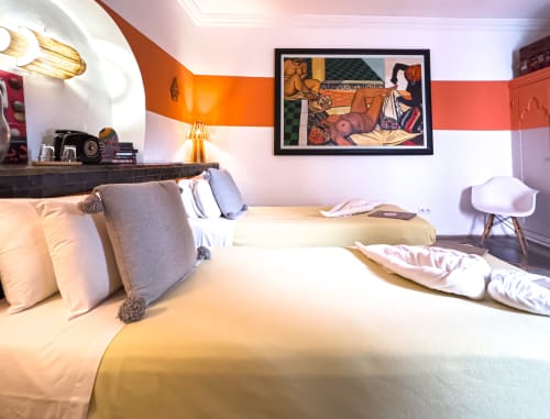 Chambre Pearl au Riad Les Lauriers Blancs à Marrakech avec lits jumeaux, mur d'accent orange et œuvres d'art modernes