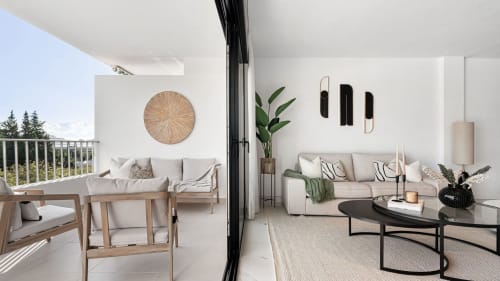 Modern Marbella apartment living room with terrace, mountain views, contemporary furnishings and minimalist décor