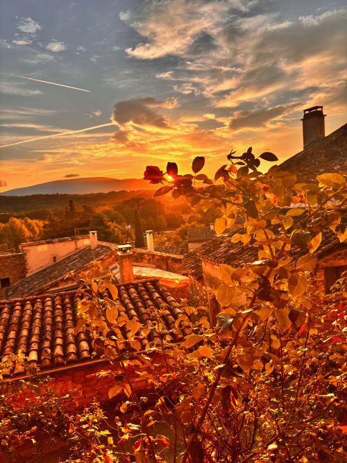 Coucher de soleil sur Grignan avec jardin de roses et toits en terre cuite à La vie de château