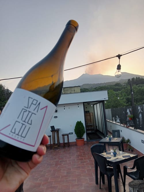 Bottiglia di vino sulla terrazza panoramica dell'Hotel Milomax con vista sull'Etna, Sicilia