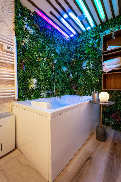 Luxurious Bordeaux apartment bathroom with jacuzzi, living green wall, neon ceiling lights, wooden accents