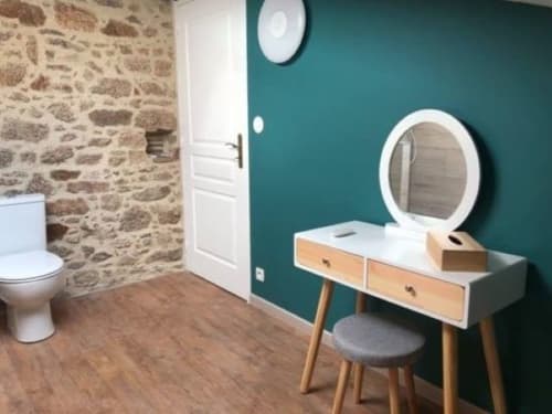 Modern bathroom in Suite du Meunier at Logis De La Bénétière, Treize-Vents, with vanity, mirror, and stone accent wall