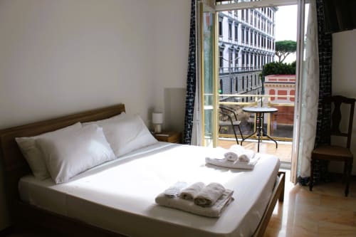 Bright bedroom at Blackwoody Contemporary Hospitality in Naples with view of city buildings and terrace
