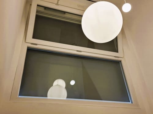 Finestra moderna dell'appartamento a Newhouse Bari con lampade a sospensione minimaliste e vista sulla città